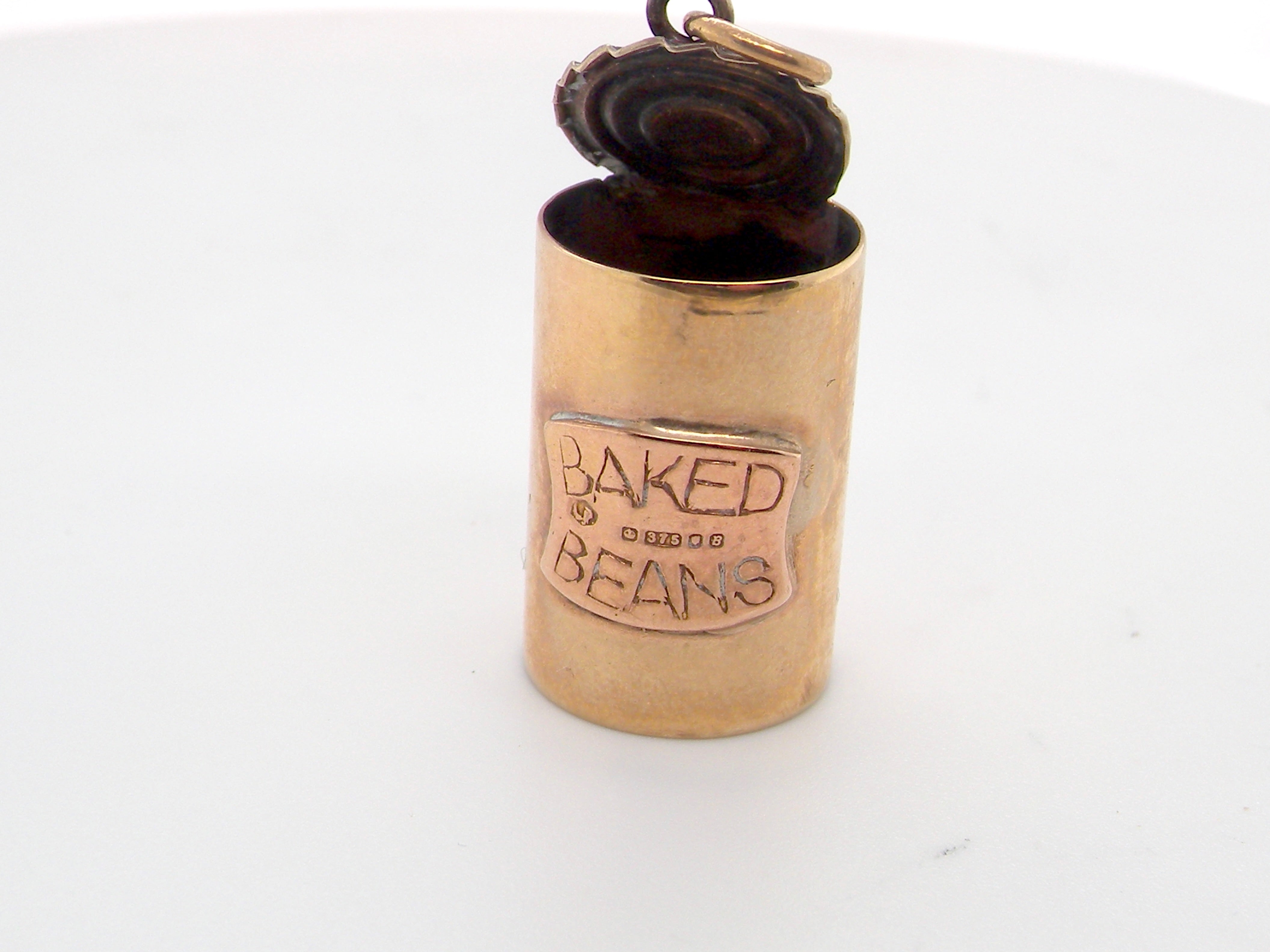 An unusual 9 carat gold charm . Shaped as a baked bean can,