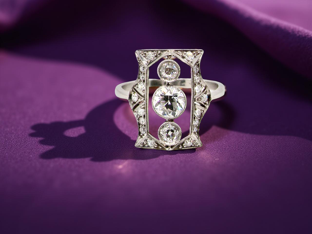 Diamond ring on a purple fabric background