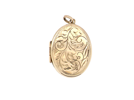 A large oval shaped locket. Measures 30x20mm. The front is hand engraved, reverse is plain.