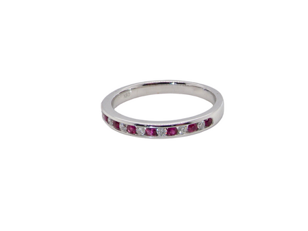 A white gold half hoop eternity ring. Set with seven round rubies and six brilliant cut white diamonds