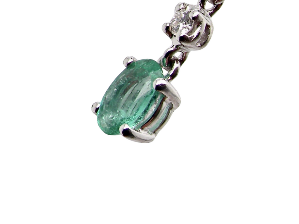 An emerald and diamond earring