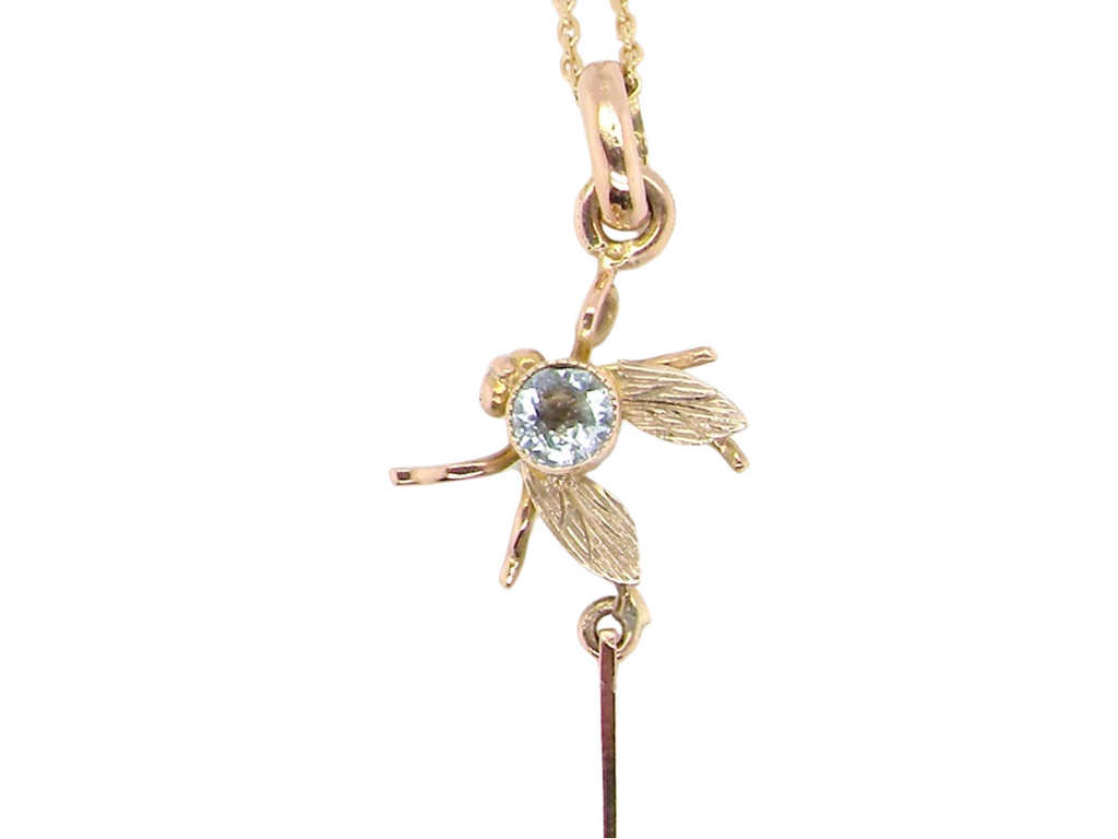 A spider and fly gold pendant