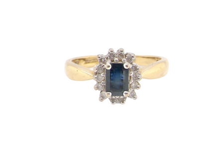 A cushion shaped sapphire and diamond cluster ring