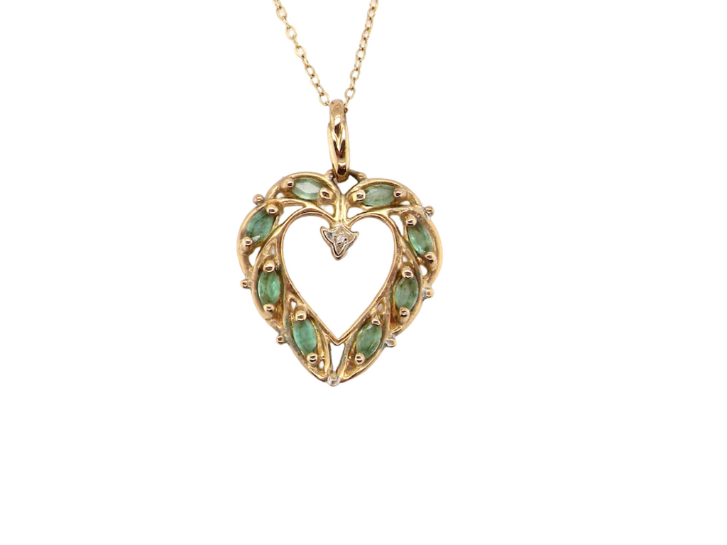 A heart shaped emerald and diamond pendant