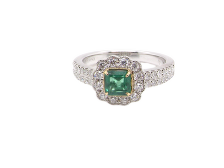A fine emerald and diamond cluster ring
