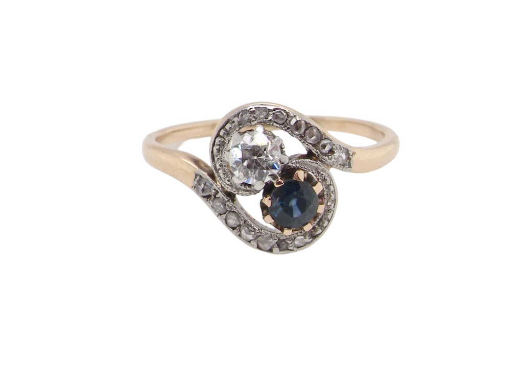 A two stone Sapphire and Diamond cross over ring