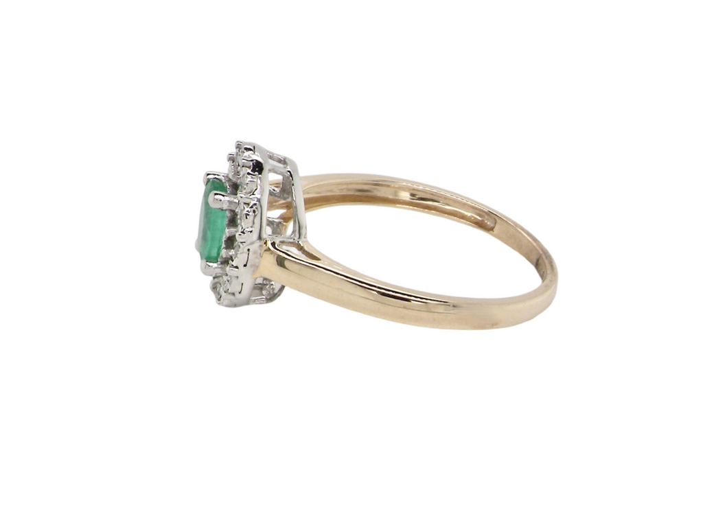 A side view emerald and diamond cluster ring