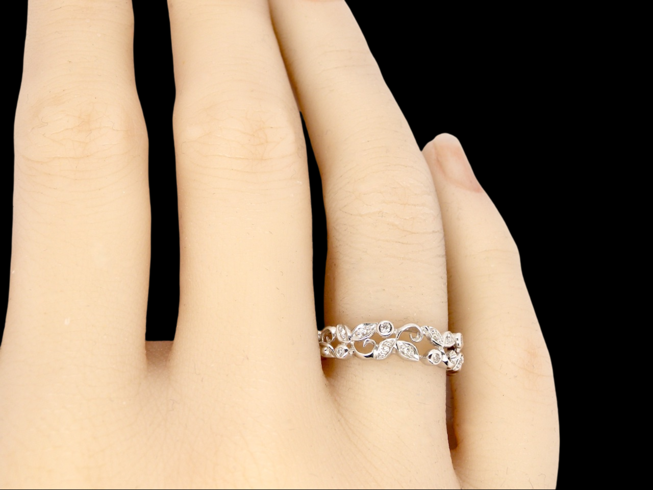 A fancy white gold foliate eternity ring