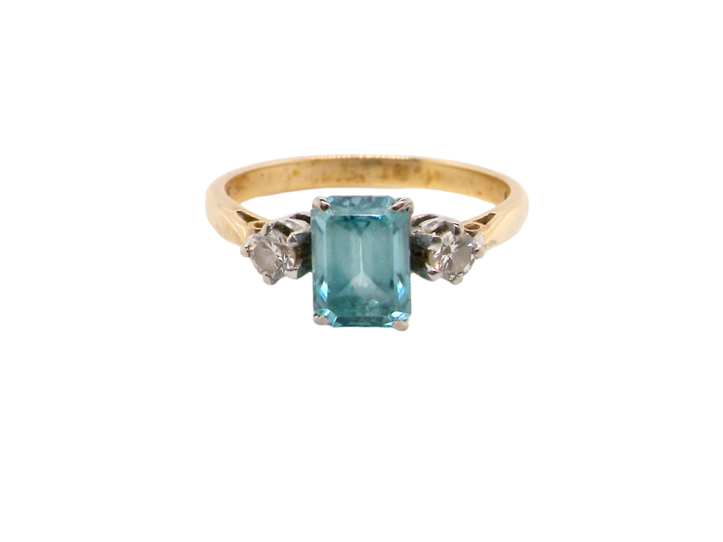 A three stone blue zircon and diamond ring
