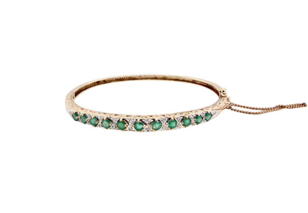 An emerald and diamond bangle