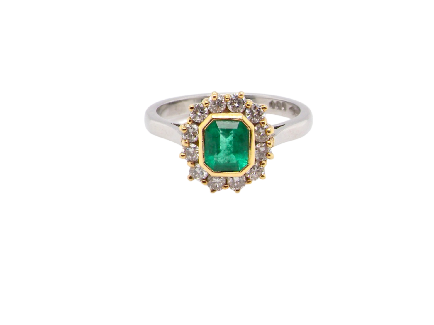 A fine emerald and diamond cluster ring