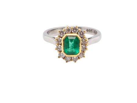 A fine emerald and diamond cluster ring