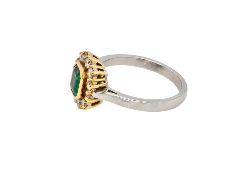 A fine emerald and diamond cluster ring side view