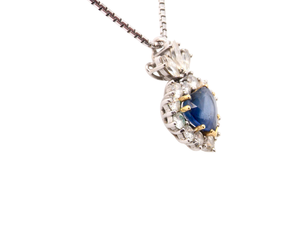 A heart shaped sapphire and diamond pendant side view