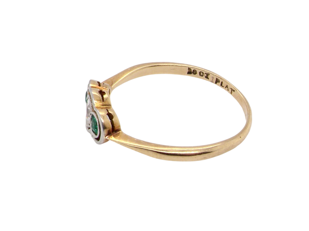 A vintage emerald and diamond ring side view