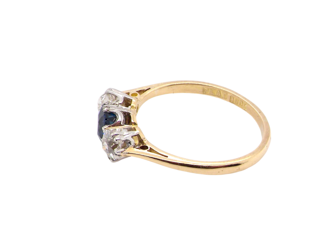 A classic three stone sapphire and diamond ring side view