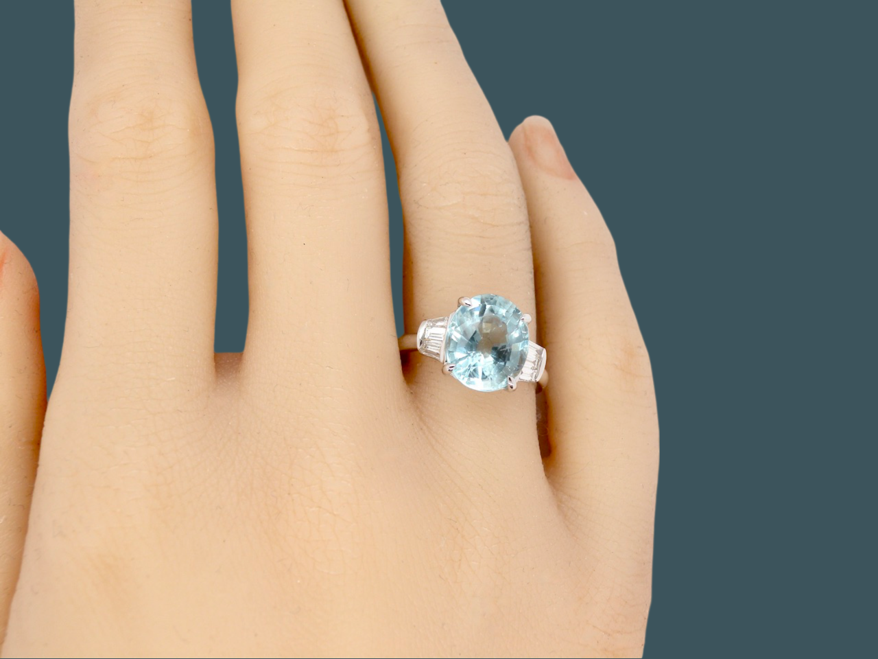 An Aquamarine and Diamond ring finger view