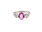 A platinum three stone pink sapphire and diamond ring