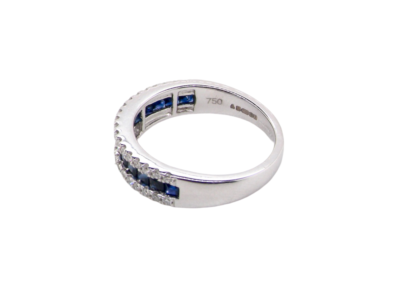 A white gold sapphire and diamond eternity ring side view