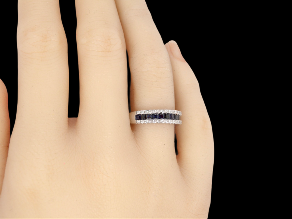 A white gold sapphire and diamond eternity ring finger view