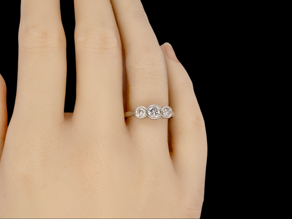 A platinum Three Stone Diamond Ring finger view