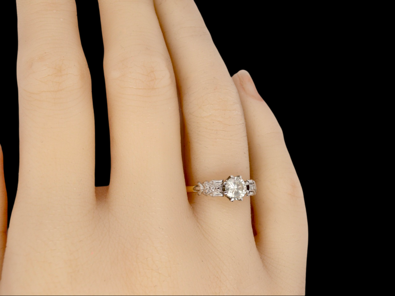 A vintage Solitaire Diamond Ring finger view