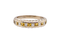 A yellow sapphire and diamond eternity ring