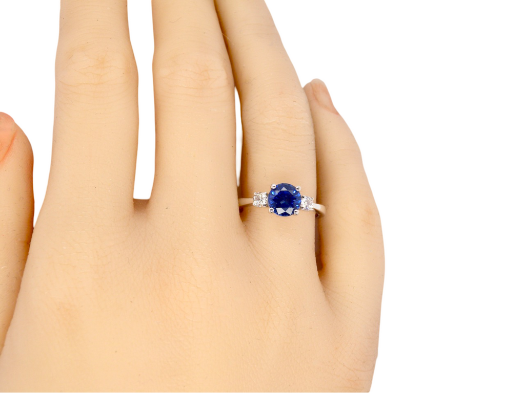 A fine three stone Sapphire and Diamond Ring finger view