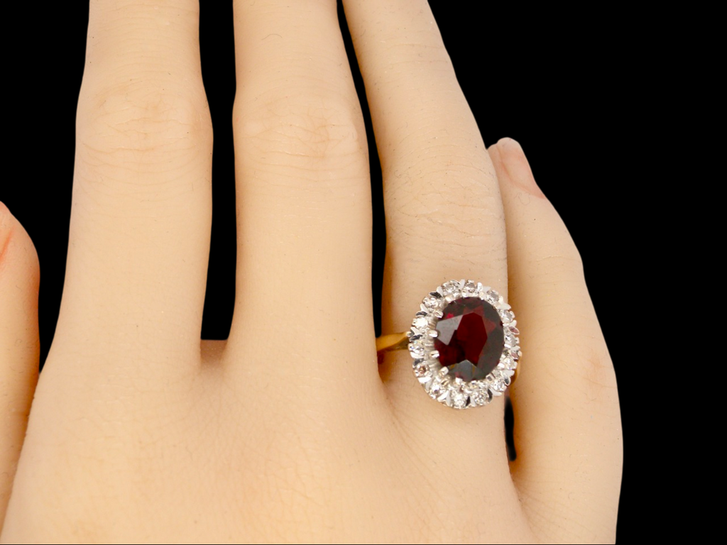 A Garnet and Diamond Cluster Ring finger view