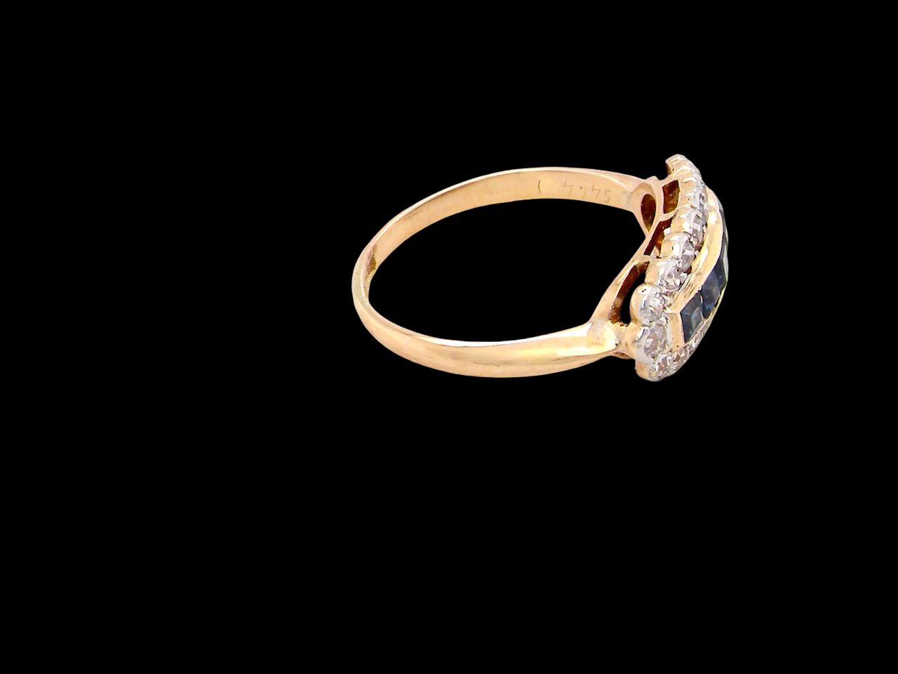 Gold ring with gemstones on a black background