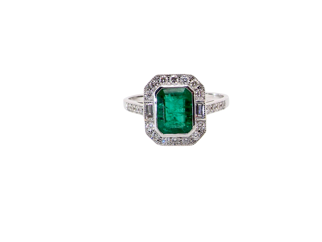 Ring with a green emerald and diamond accents on a white background