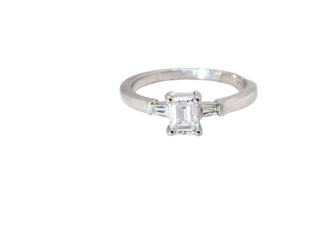 An 18 carat white gold emerald cut diamond ring