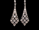 Designed in the elegant style of the 1920s, these sophisticated drop earrings are crafted in  white gold.
