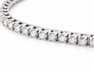A close-up of a diamond tennis bracelet set in a silver-colored metal, shown on a clean white background.