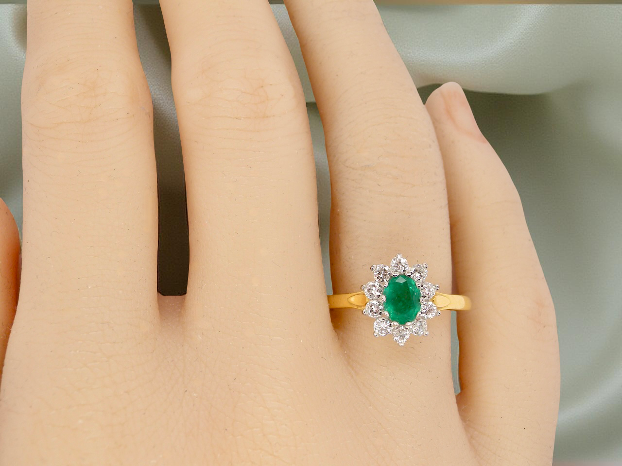 An 18 carat gold Emerald and Diamond cluster ring
