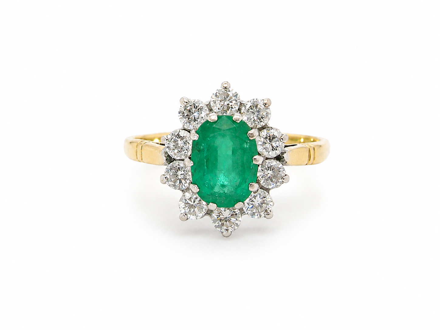 Features an oval cut emerald centre stone, vibrant green hues, measures 9x6mm(est 1.75 carats) . Complimented by an outer halo of ten 2.7mm brilliant cut white diamonds (est total 0.60 carats) 