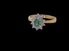  Features to the centre an oval shaped emerald, 5.5x4.5mm (est 0.35 carats) deep green colour.&nbsp;