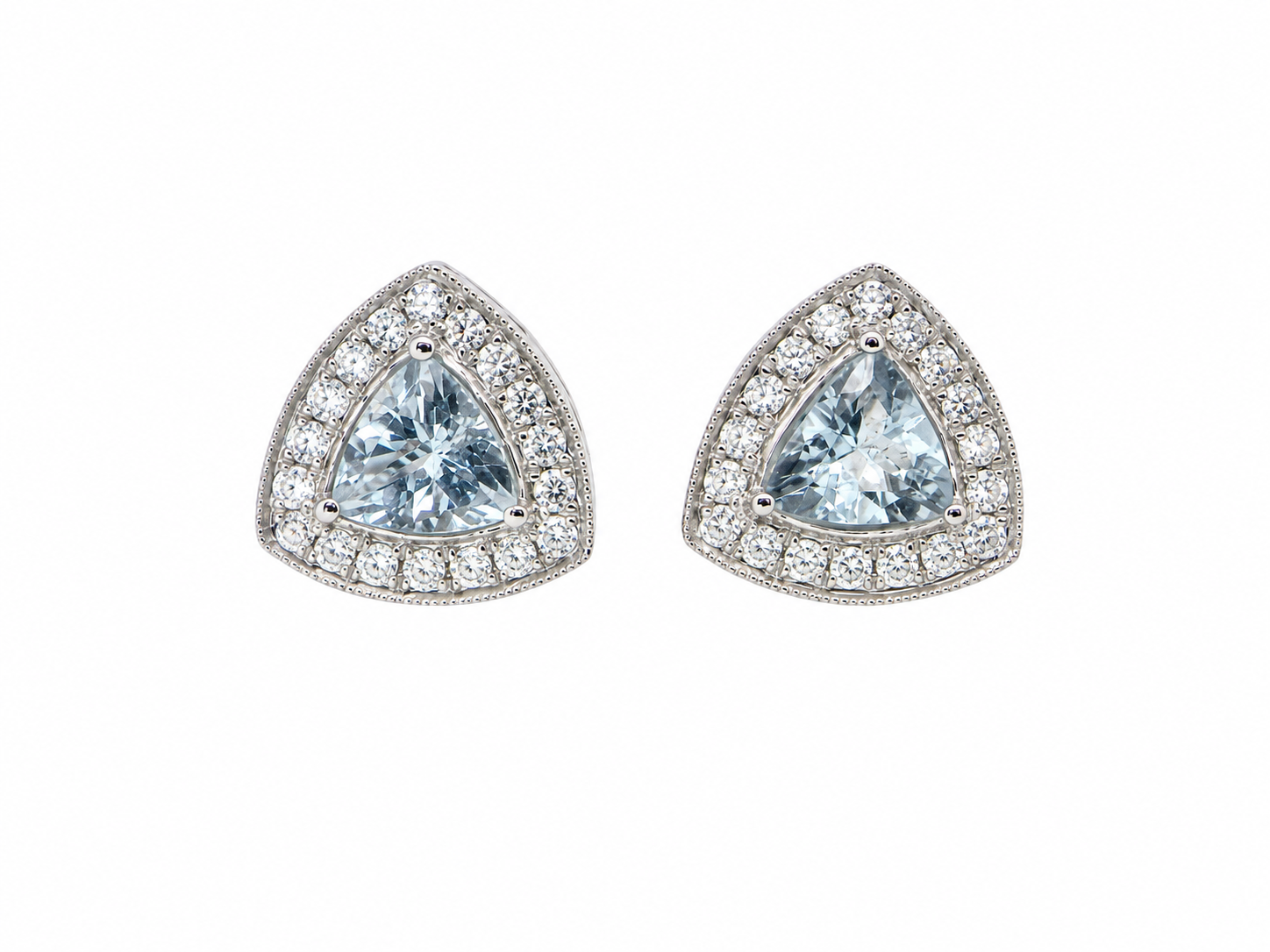 A fine pair of 18 carat white gold cluster earrings, each containing a trapeze cut aquamarine 6x6x6mm (1 carat) surrounded by eighteen x 0.02 carat brilliant cut white diamonds.