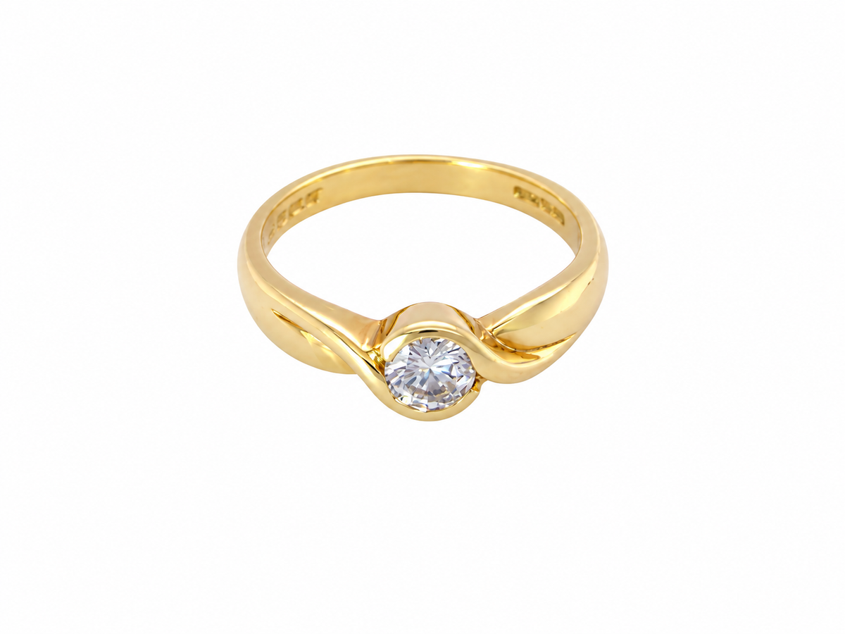 A yellow gold solitaire ring with a round-cut clear gemstone, set in a twisted band design, shown on a plain white background.