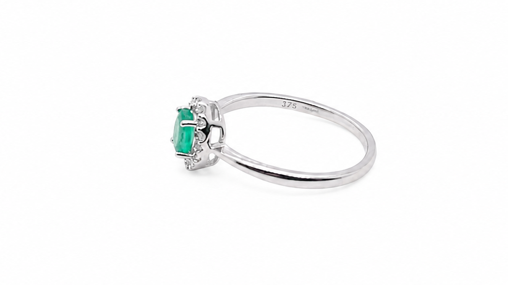 white gold ring with a green gemstone on a white background side image 