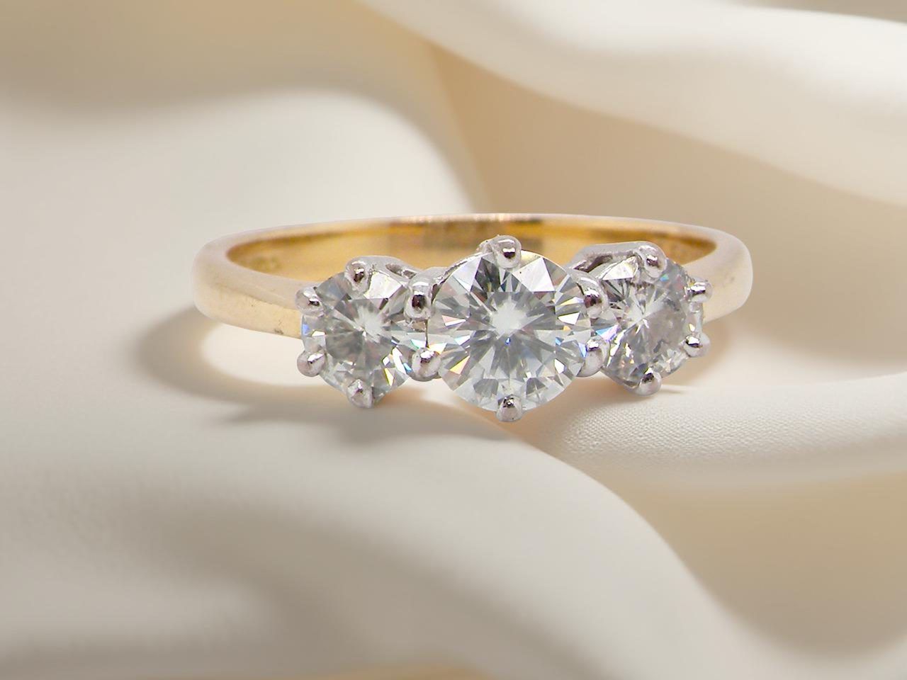 The iconic trilogy ring. This example set with  fine brilliant cut white diamonds