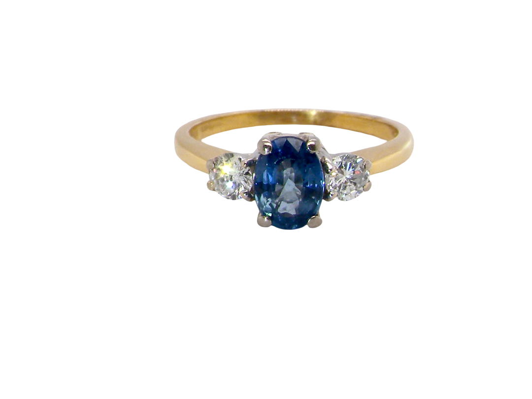 The iconic trilogy ring, featuring an oval cut sapphire centre stone, with a pleasing mid blue hue set into four claws, 7x5mm 