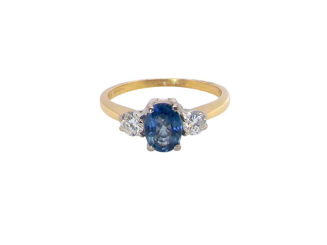 The iconic trilogy ring, featuring an oval cut sapphire centre stone, with a pleasing mid blue hue set into four claws, 7x5mm (0.75 carats est)