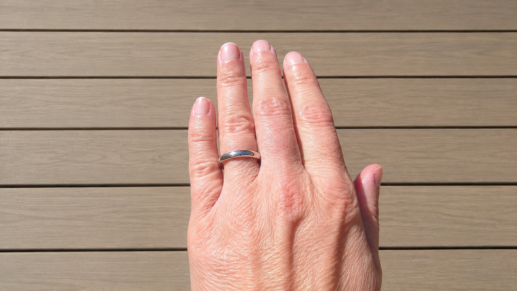 White gold 3mm wedding band on a hand 
