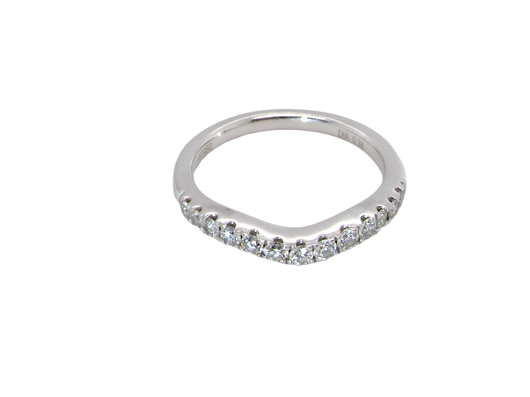 above A Platinum half hoop ring featuring a gently contoured U-shaped centre, designed to allow a cluster or solitaire ring to sit comfortably alongside.