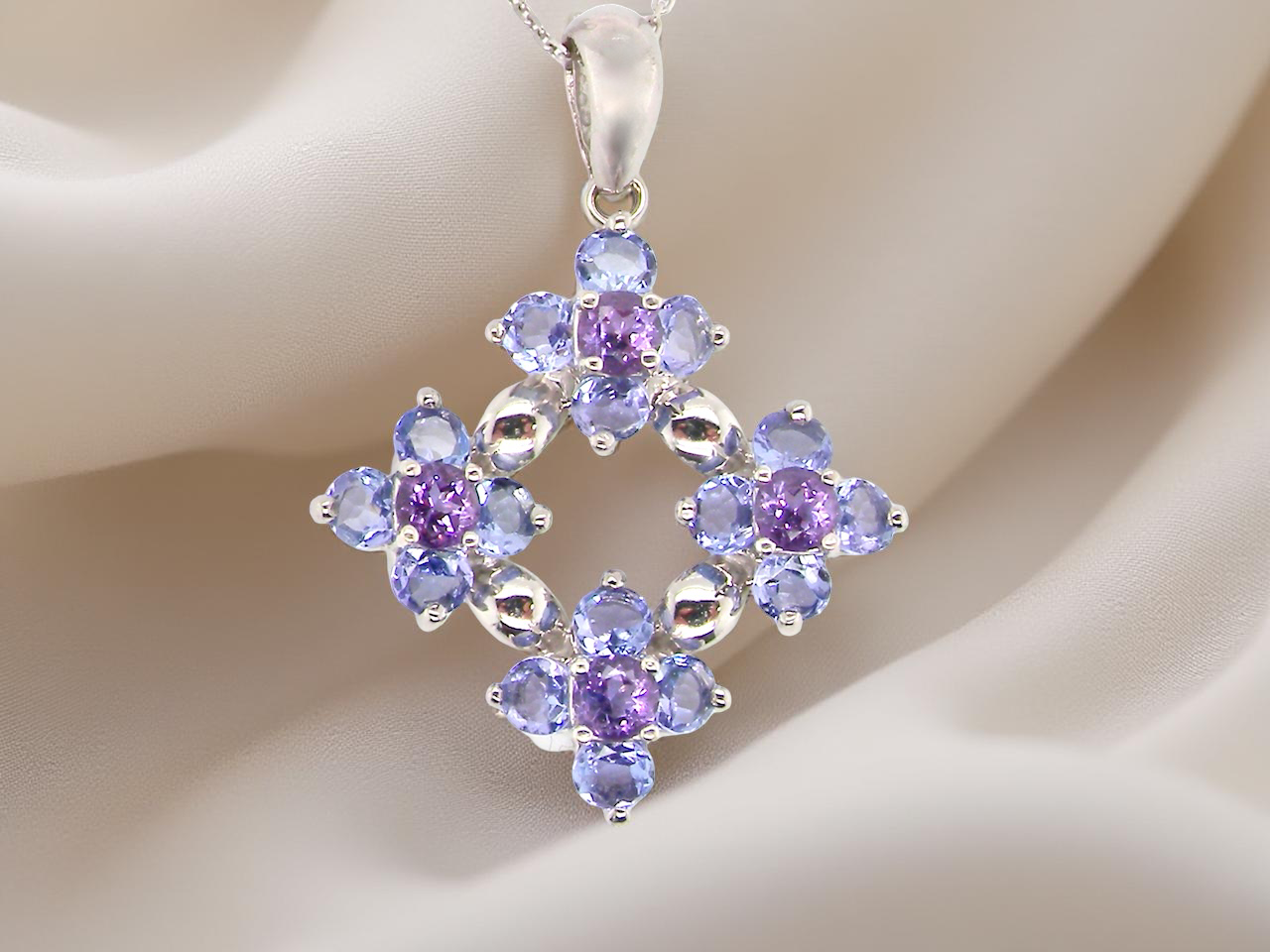 A white gold amethyst and tanzanite pendant