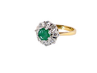  beautiful cluster ring featuring a&nbsp;round emerald 