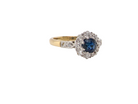  beautiful mid-century cluster ring featuring a dark blue sapphire 