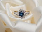  beautiful mid-century cluster ring featuring a round blue sapphire 