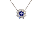 beautiful new 18 carat white gold cluster pendant, showcasing a blue sapphire at its centre.
